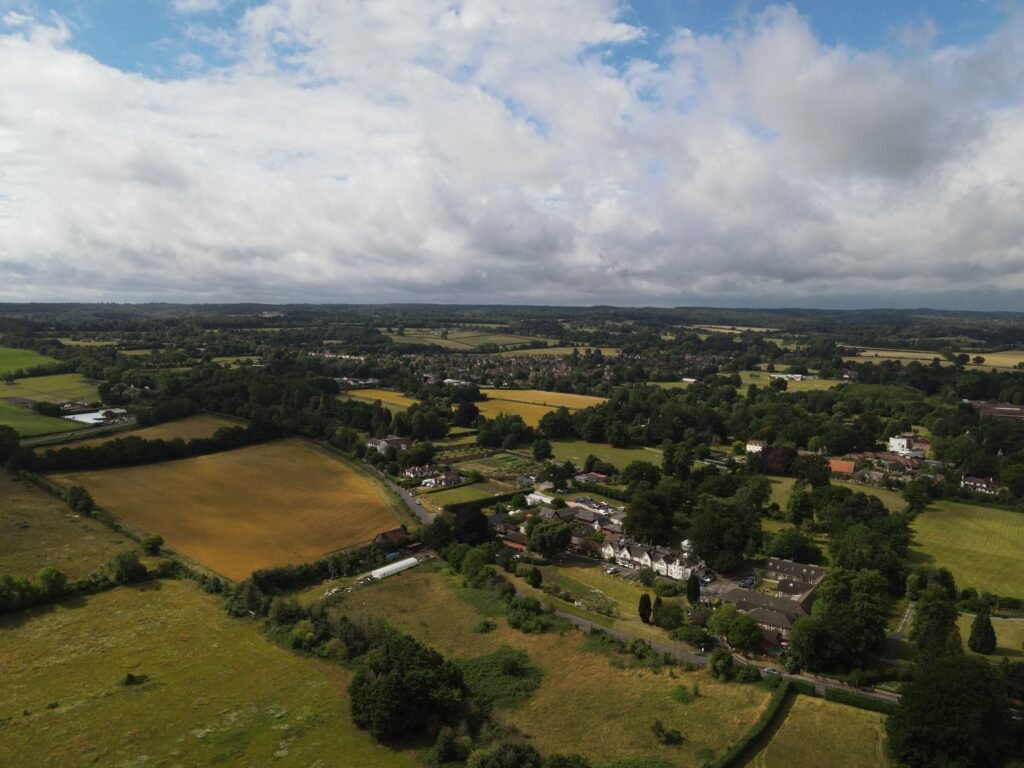 An aerial view of fields, scattered homes and woodland. Exact location is not confirmed.