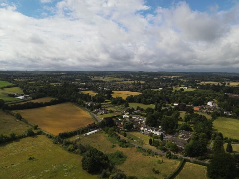 An aerial view of fields, scattered homes and woodland. Exact location is not confirmed.