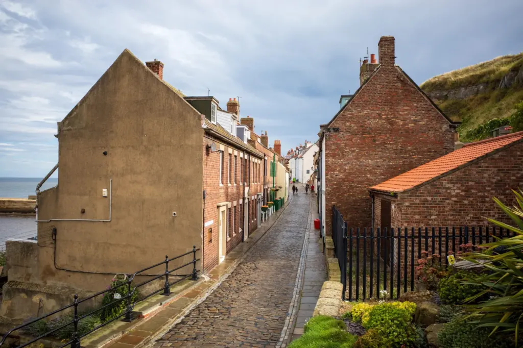 A narrow cobbled street between houses in Whitby
